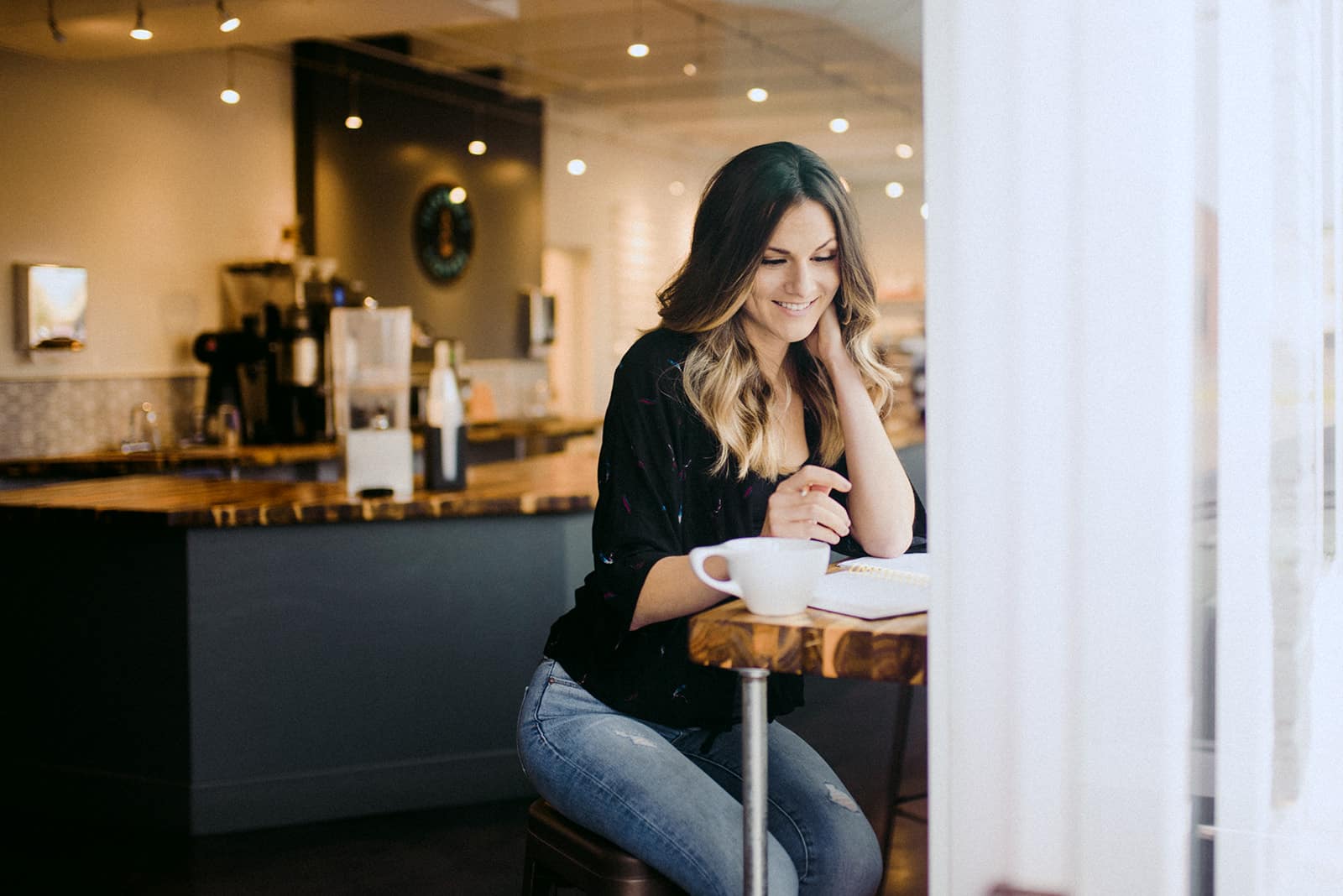 woman smiling at coffee bar